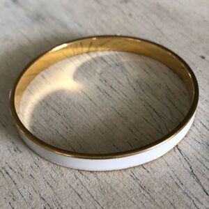 Monet White enamel and gold thin bangle bracelet.